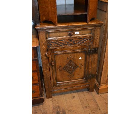 Good quality reproduction oak side cabinet, the single drawer above a carved panel door 