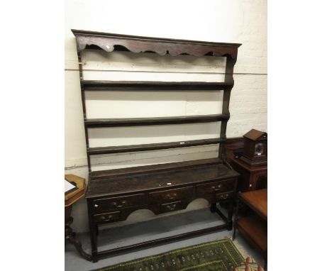 18th Century oak dresser, the associated shelf back above a moulded top with six drawers and a shaped frieze raised on turned