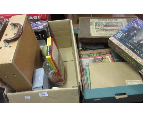 Two boxes containing a quantity of various children's toys and games including Lord of the Rings, children's puzzles and a bo