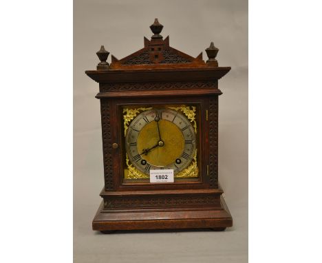 Late 19th Century German oak cased mantel clock, the square gilded and silvered dial with Roman numerals, with a two train mo