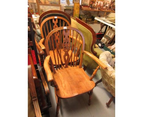 Pair of early 20th Century elm and beech wheel and stick back elbow chairs on turned supports 