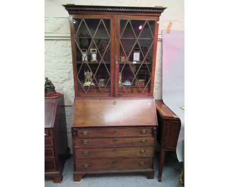 19th Century mahogany bureau bookcase having a moulded key pattern cornice above two astragal glazed doors enclosing adjustab
