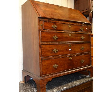 George III mahogany bureau, the fall front enclosing a fitted interior above four graduated drawers with later brass handles 
