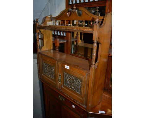 Late Victorian oak wall bracket with two carved panel doors and open shelves 