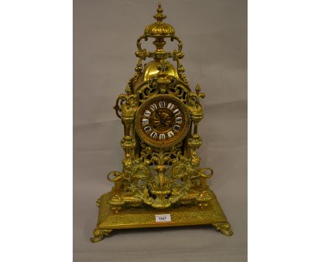 Large 19th Century gilt brass mantel clock with urn surmount, the case of open work design and decorated at the base with fig