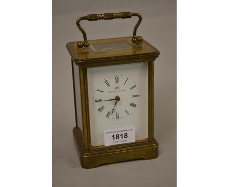 Mathew Norman, a brass cased carriage clock, the enamel dial with Roman numerals, the two train movement striking on a gong 