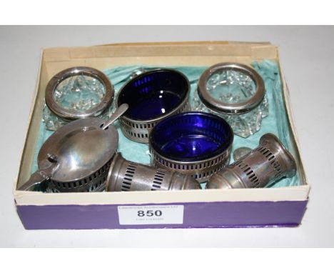 Five piece silver condiment set with blue glass liners, together with a pair of silver mounted cut glass trinket dishes 