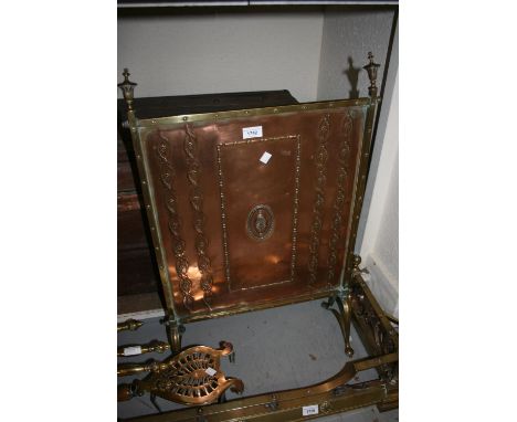Arts and Crafts brass framed firescreen with copper embossed panel, 30ins high x 20ins wide 