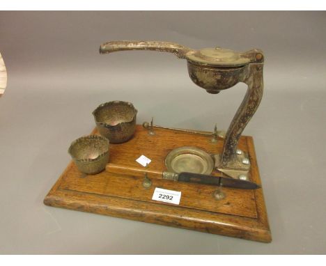 Unusual early 20th Century oak and silver plated lemon squeezer on stand with various accessories 
