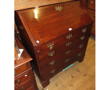 George III mahogany bureau, the fall front enclosing a fitted interior above four graduated drawers with brass handles and es