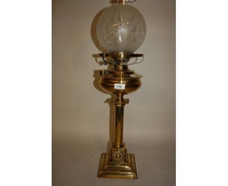 Arts and Crafts brass oil lamp, the brass well above a plain column support with stylised appliques to the base above a squar