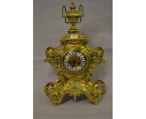 Large 19th Century French gilt brass mantel clock of rococo design, the shaped case with an urn surmount decorated with shell