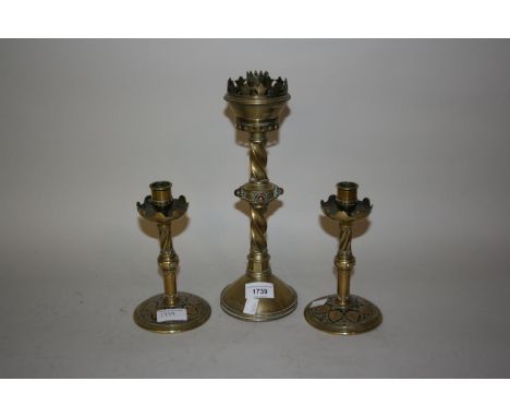 Victorian Gothic Revival candlestick, together with a pair of similar smaller candlesticksThe pair are 17cm tall and the sing