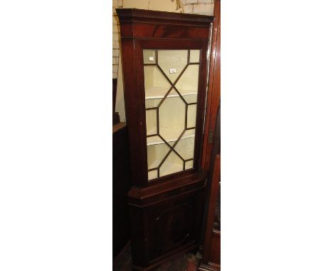 Mid 20th Century mahogany standing corner cabinet in George III style, with an astragal glazed door above a panelled door on 