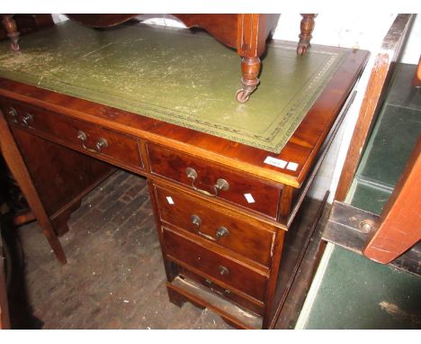 Reproduction yew wood twin pedestal desk with a green leather inset top above nine drawers on bracket feet 