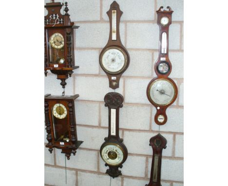 A Victorian carved oak banjo wall barometer and a second similar barometer. (2)