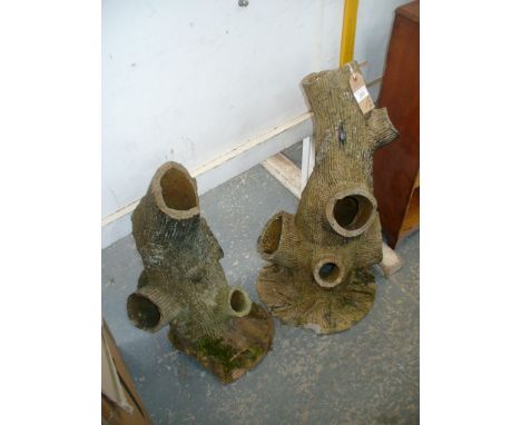 Two reconstituted stone naturalistic trunk planters.