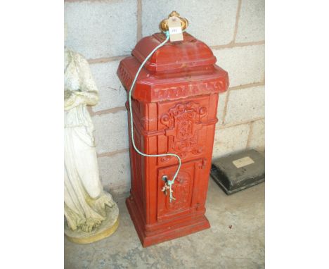 A freestanding iron post  box with a gilt crown finial.