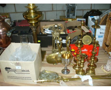 A Victorian brass column oil lamp, two gilt metal easel frames, a pair of brass fire dogs, three brass fire irons, three pair