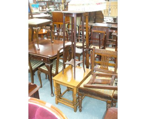 An Oak nest of three tables, two oak plant stands and a lamp standard (4)