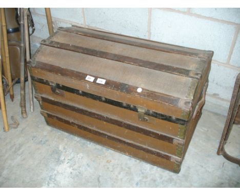 A Vintage canvas and slatted hardwood domed trunk.