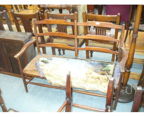 A 19th Century stained beech wood ladder back and rush seated two seater settee.