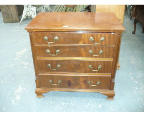 A Georgian style mahogany chest of drawers
With a rectangular moulded top above four cockbeaded graduated long drawers each w