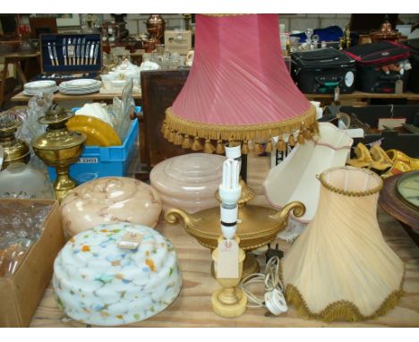 Three early 20th Century marbled glass pendent light shades, a brass Corinthian column table lamp and two other lamps.