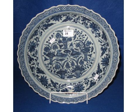 Large Chinese Yuan style blue and white porcelain dish having repeat serpentine rim diaper and lotus scroll work bands, the c