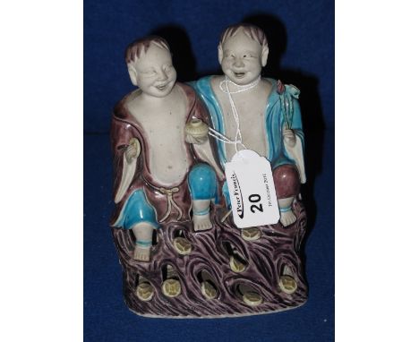 Chinese porcelain figure group, The He-He twins with coloured enamel glazes over parian finish. CONDITION REPORT: Both appear