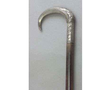 A 19th century walking stick. Carved cane and lacquer shaft and a silver handle, 90 cm. long.