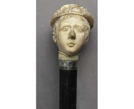 A first third of 20th century walking stick. Carved ebony shaft and a bone handle carved in the shape of the bust of a dame w