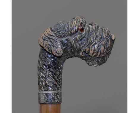 A walking stick circa 1900. Carved bamboo shaft and an antler handle carved in the shape of a dog with glass eyes, 93 cm. lon