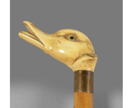 A 19th century English walking stick. Carved fruitwood shaft and an ivory handle carved in the shape of a duck with glass eye