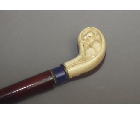 A 20th century walking stick. Lacquer wood shaft and a wood andivory handle carved in the shape of a putter hidding a mouse w