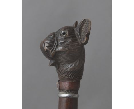 A 19th century walking stick. Having a fruitwood shaft and a wood handle carved in the shape of a dog head with a jointed mou