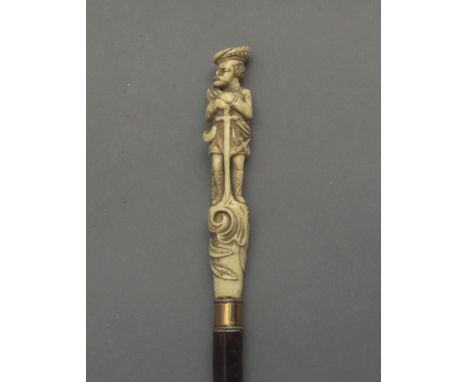 A 19th century English walking stick. Carved wood and tortoiseshell shaft and an ivory handle carved in the shape of a man we