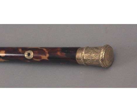 A first half of 20th century walking stick. Carved wood and tortoiseshell shaft and an 18k. yellow gold handle and details, 8