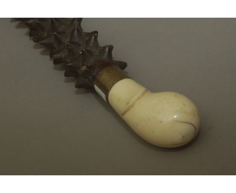 A first third of 20th century walking stick. Carved wood prickly shaft with a carved ivory handle and a metal joint, 89 cm. l