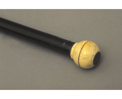 A 19th century possibly Enlglish walking stick. Carved ebony shaft and an ivory handle carved in the shape of a sphere witha 