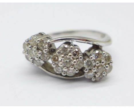 An 18ct white gold and diamond cluster ring, approximate diamond weight 1carat, in three daisy clusters, 6.1g, O 