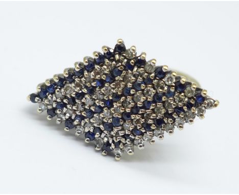 A 9ct gold ring set with fifty diamonds and fifty sapphires, 4g, K 