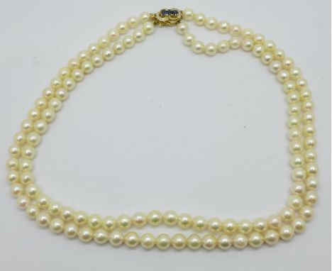 A double strand pearl necklace, with 14ct gold, sapphire and diamond clasp 
