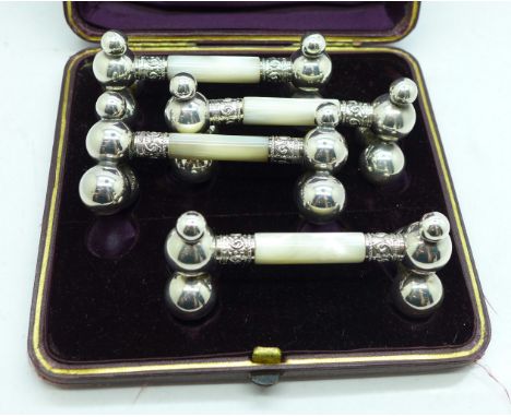 A cased set of four silver plate and mother of pearl knife rests 