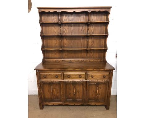 Mid Century Ercol welsh dresser, in dark elm, three cupboard base with three drawers above, supporting removeable three shelf