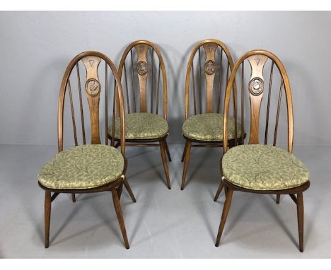 Mid century Furniture, four Ercol swan back dining chairs with green leaf seat pads 