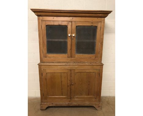 Antique Pine larder cupboard of two sections, the base with two opening doors and internal shelf, the removeable top with two