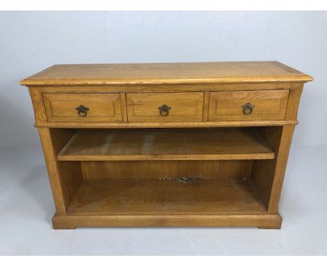 Modern blonde oak side board, three top drawers with open base and single shelf approximately 127 x 39 x 86 cm 