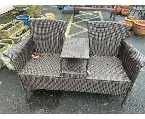 Garden Furniture: A two seater garden wicker style bench with integrated table 