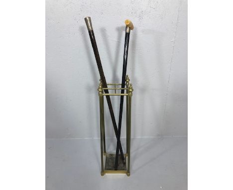 Two Antique walking canes of hardwood, one with a silver top the other with a silver collar and imitation ivory handle, along